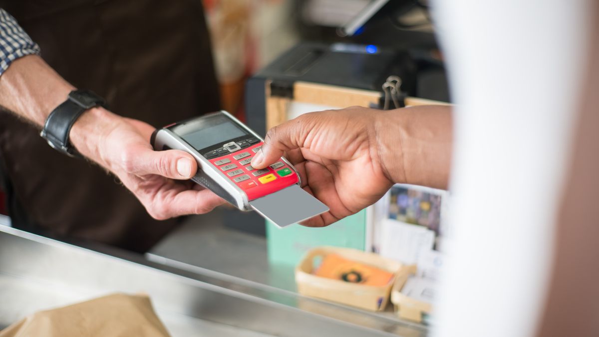Customer paying with a bank card at a stall