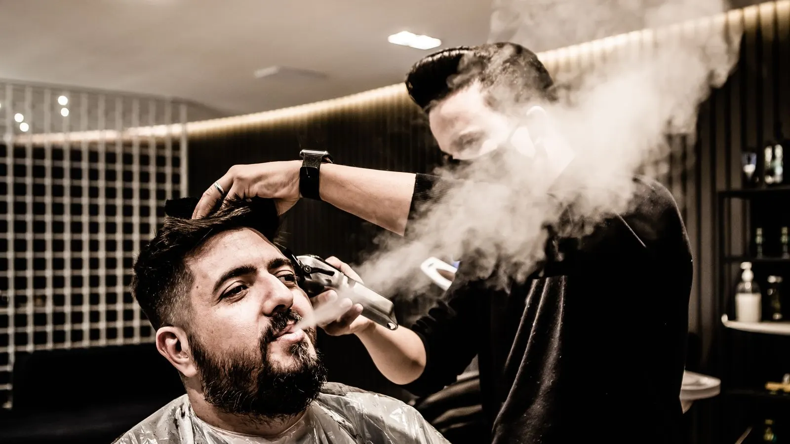 Client having a haircut in a barbershop chair