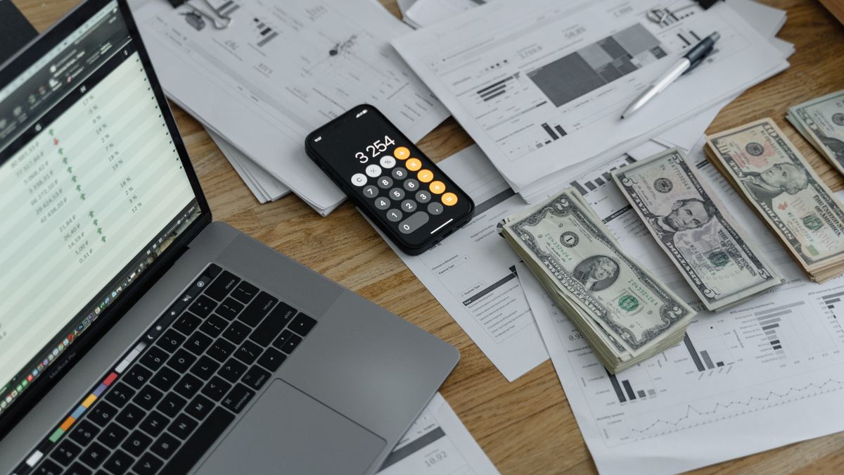Calculator and banknotes on a desk