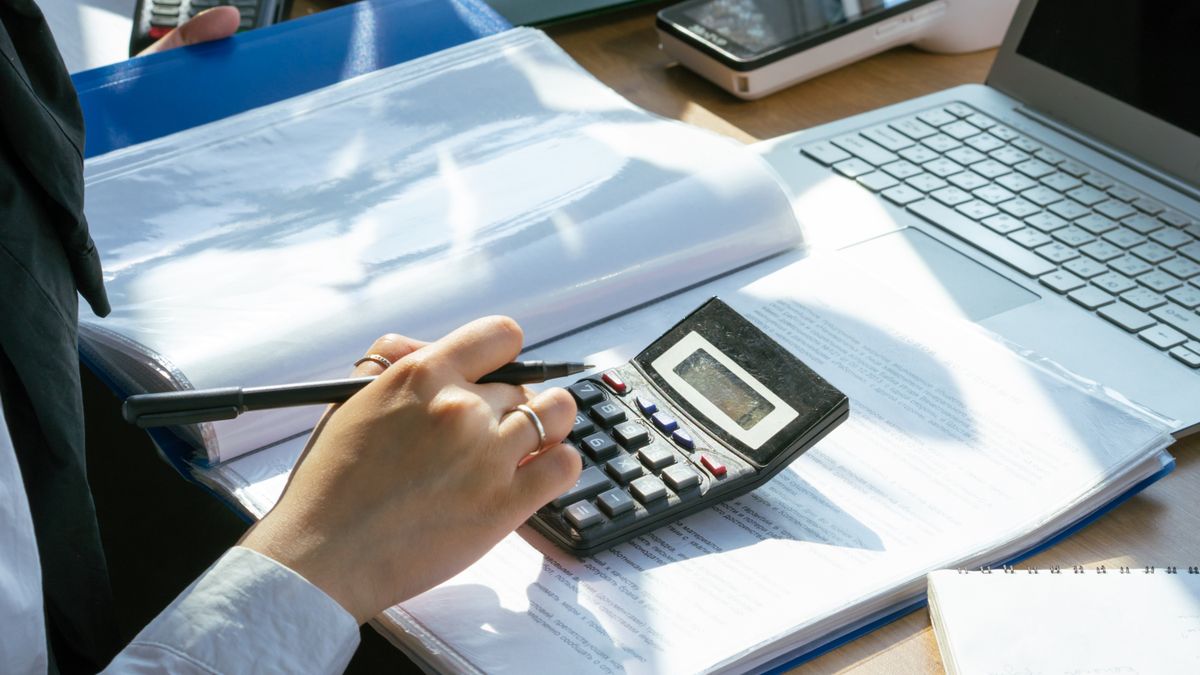 Person reviewing costs with a calculator