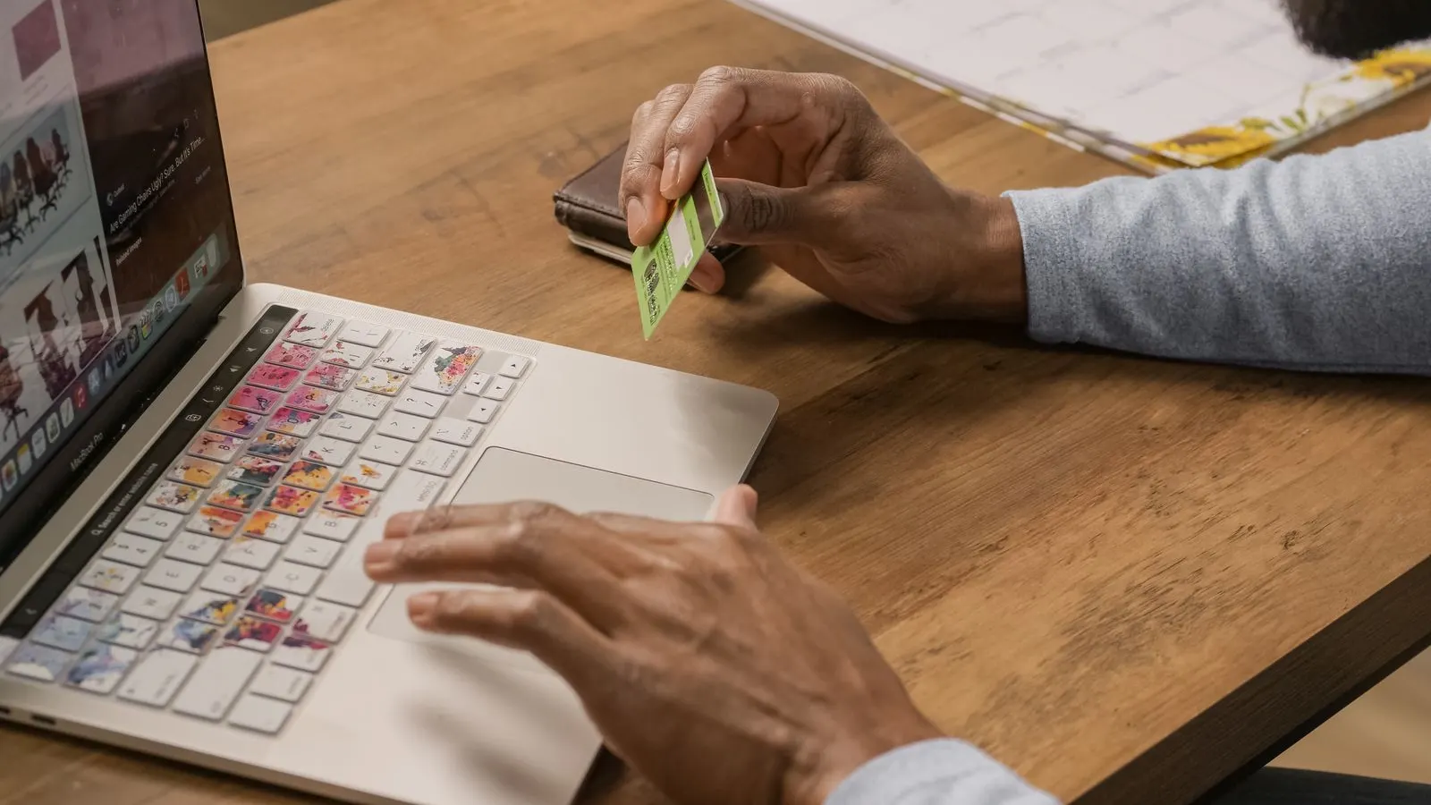 Business owner checking a card statement at a laptop