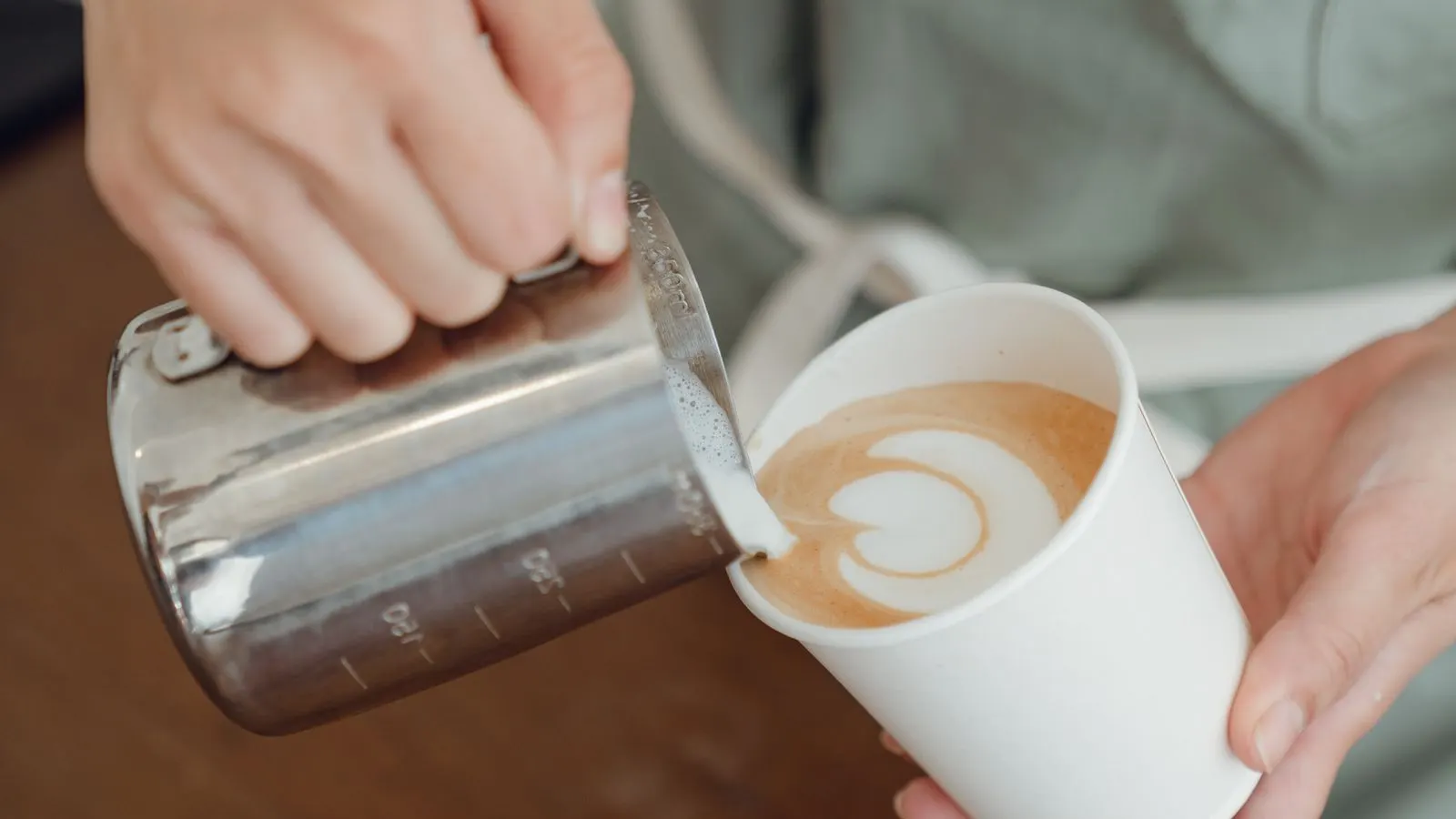 Barista preparing coffee behind a cafe counter