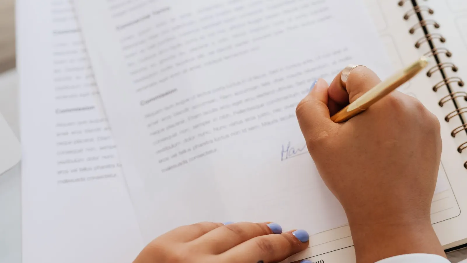 Close-up of a person signing an agreement